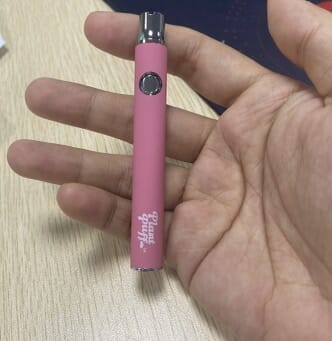 User holding 510 Thread Battery with Plant Puff™ Logo